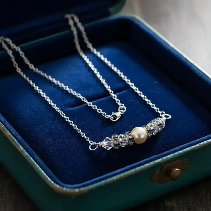 Silver Swarovski Crystal Pearl Bar Bridal Necklace displayed in a blue jewelry box.
