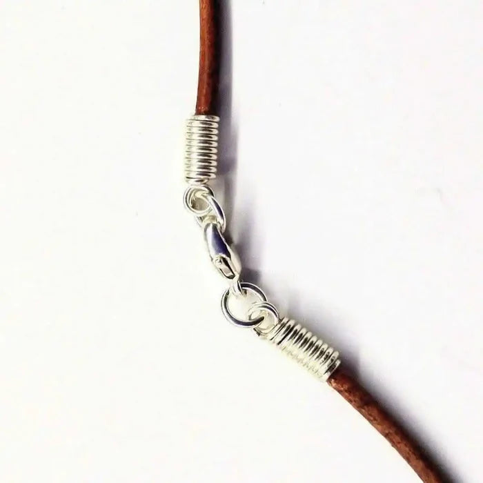Silver Wrapped Light Amethyst Point Gemstone Necklace clasp detail with silver coil and brown leather cord.
