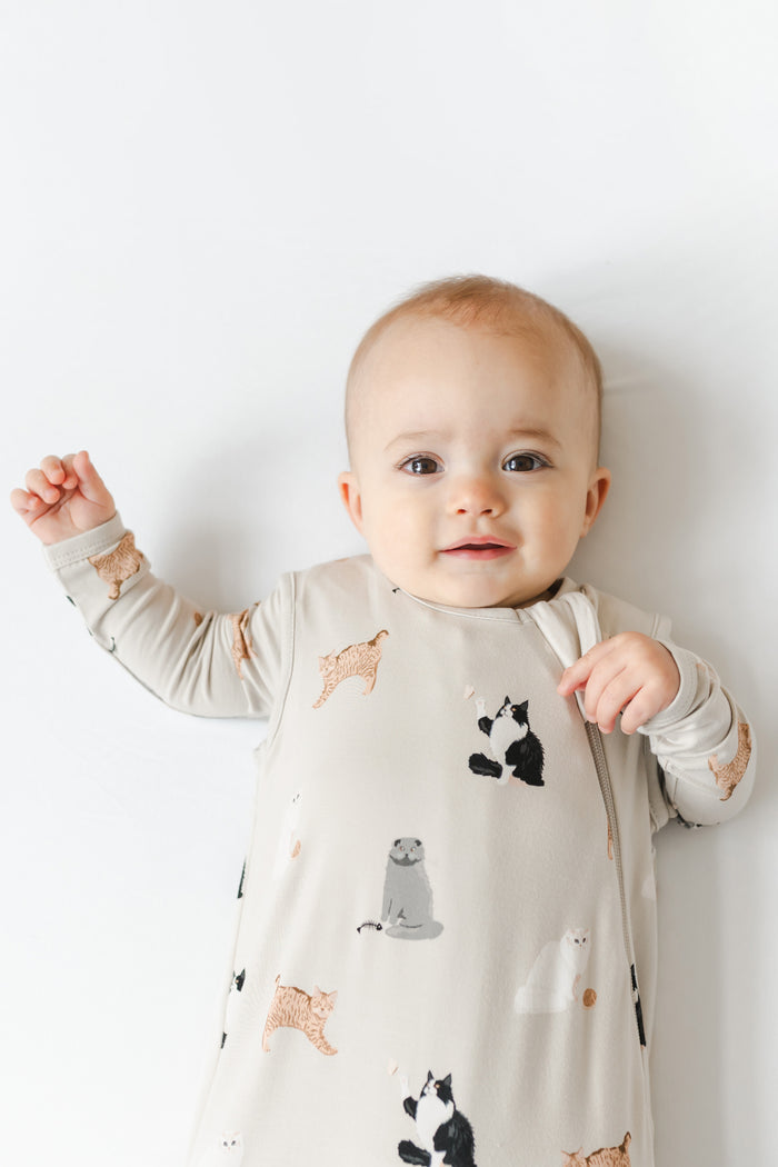 Baby in a cat patterned sleep sack