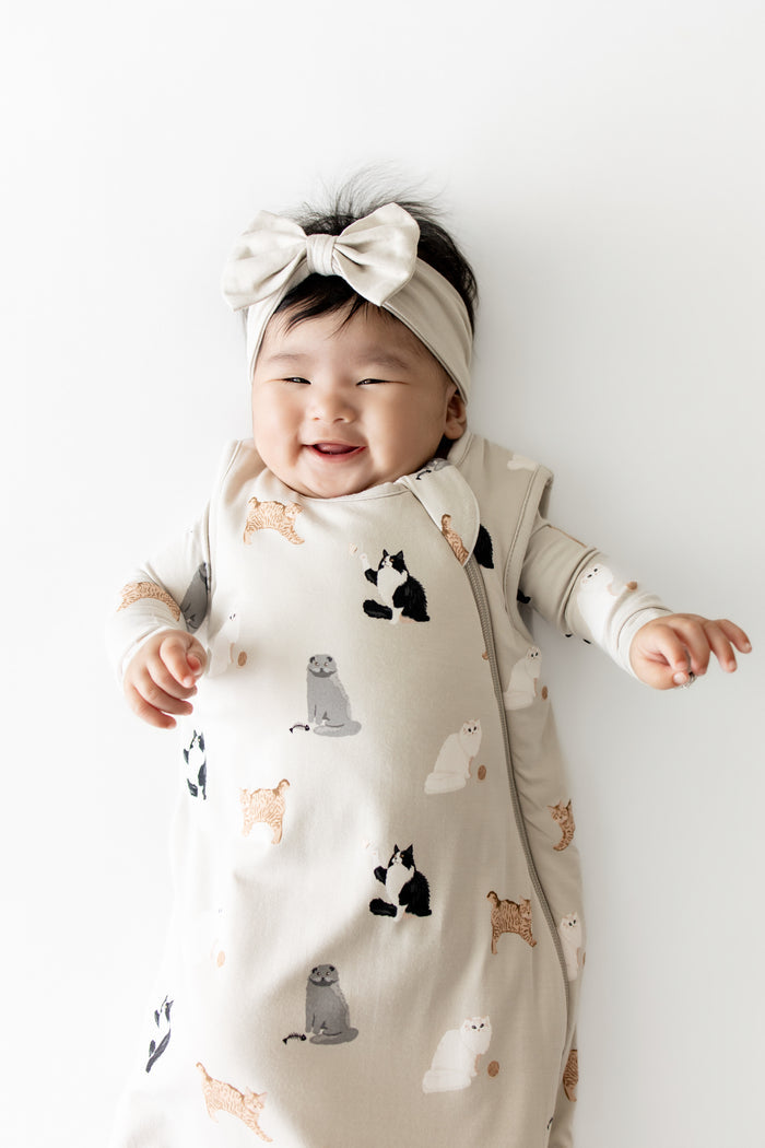 Close up of smiling infant wearing the Sleep Bag in Fluffy Cat 1.0