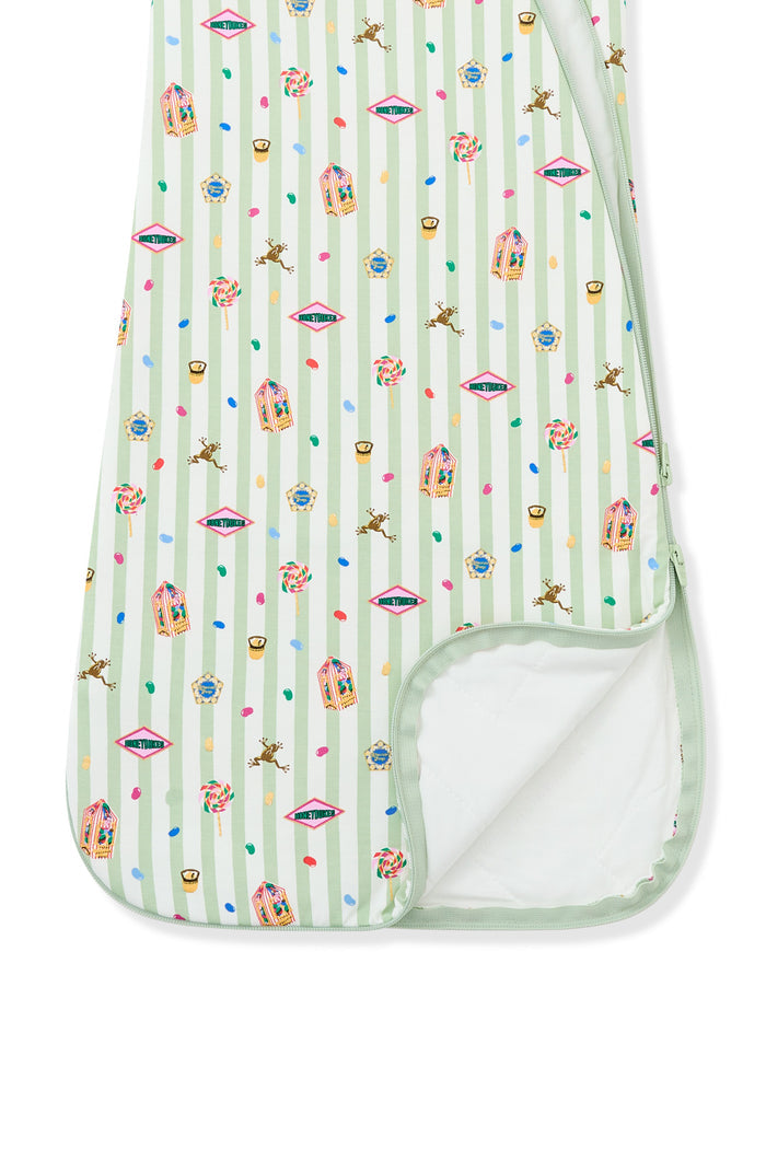 Bottom part of the sleep bag with colorful Harry Potter patterns on green and white striped fabric a white background