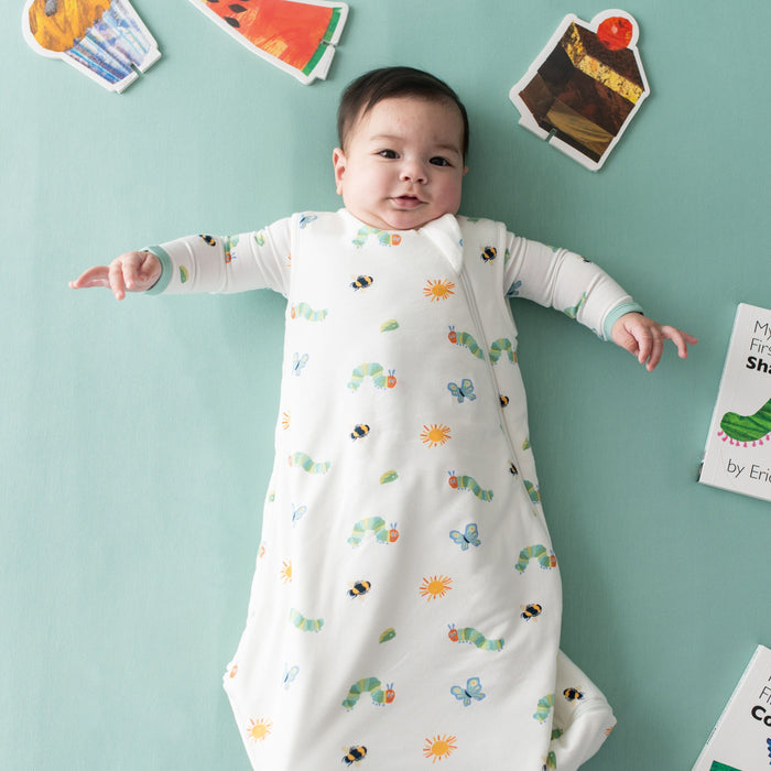 Baby wearing Kyte Baby bamboo TOG 1.0 Sleep Bag in The Very Hungry Caterpillar™ and Friends