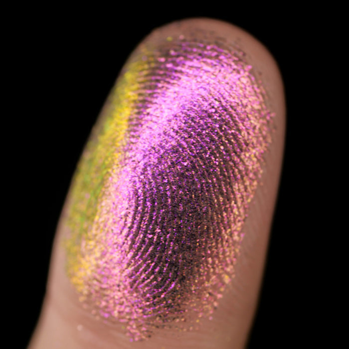 Macro finger swatch of Smoulder Lite on fair skin tone.