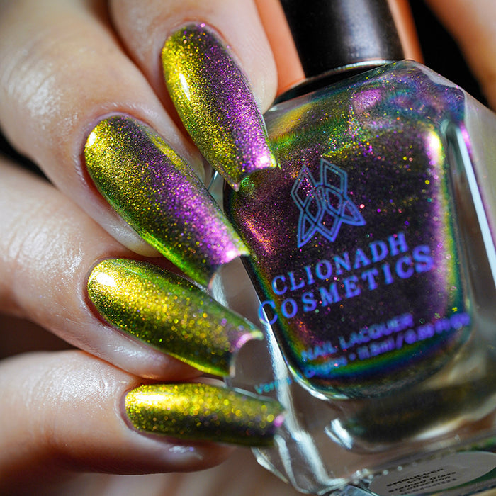 Close up shot of nails done with Smoulder Lite nail lacquer on fair skin tone holding the nail lacquer bottle