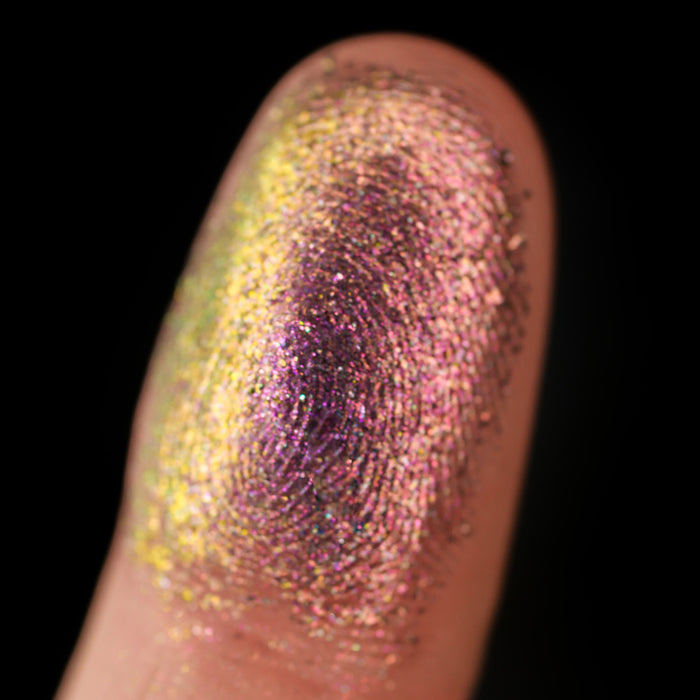 Macro finger swatch of Solder Dimensional Multichrome on fair skin tone.