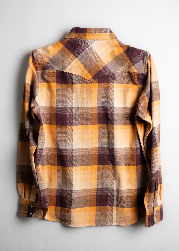 Plaid flannel shirt in yellow, brown, and orange hues, displayed flat on a white background, showcasing its back design.
