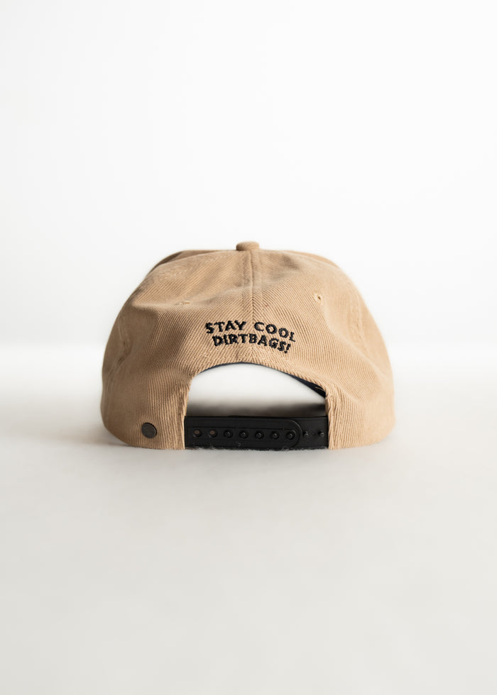 Tan cap with black adjustable strap, embroidered with "Stay Cool Dirtbags!" on the back, set against a plain white background.