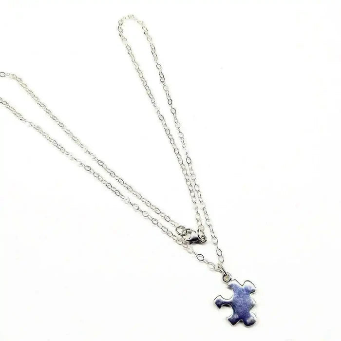 Sterling Silver Autism Awareness Puzzle Piece Chain Necklace displayed on a white background with a delicate chain.