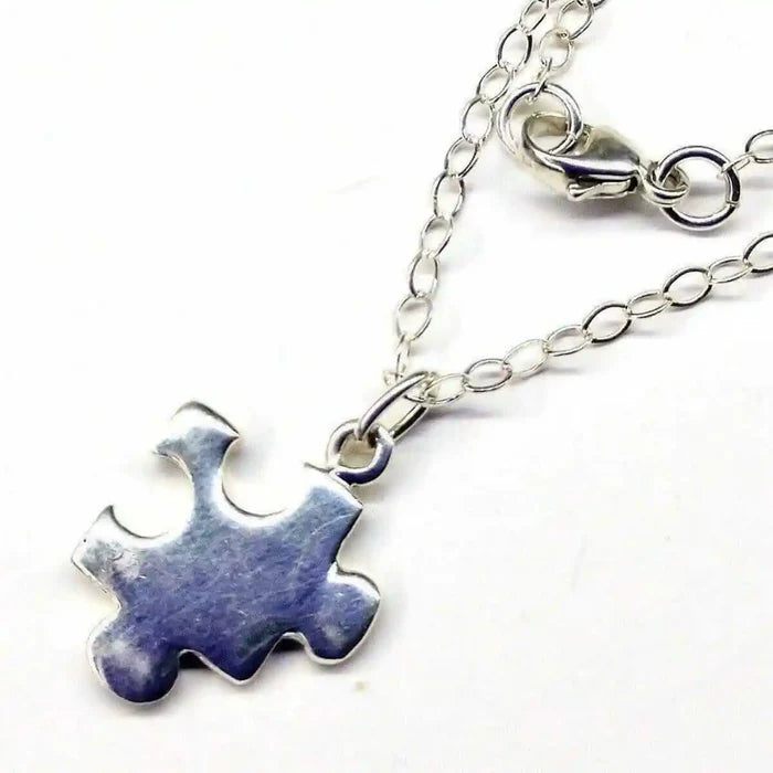 Sterling Silver Autism Awareness Puzzle Piece Chain Necklace with a shiny silver puzzle piece pendant.