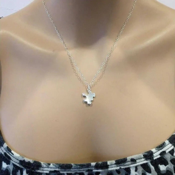 Sterling Silver Autism Awareness Puzzle Piece Chain Necklace displayed on a mannequin, showcasing its elegant design.