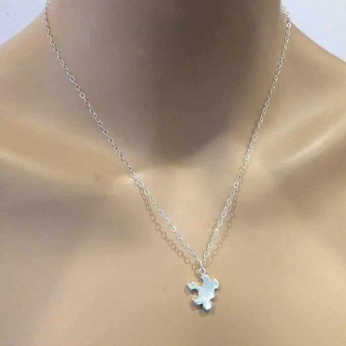 Sterling Silver Autism Awareness Puzzle Piece Chain Necklace displayed on a mannequin's neck highlighting its elegant design.