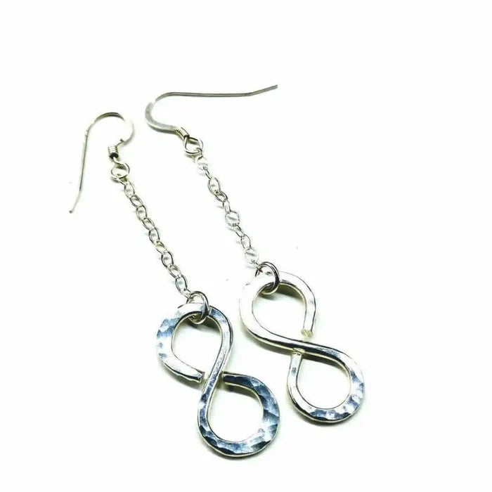 Sterling Silver Hammer Patterned Infinity Earrings hanging on a chain, showcasing their elegant design and artisan craftsmanship.