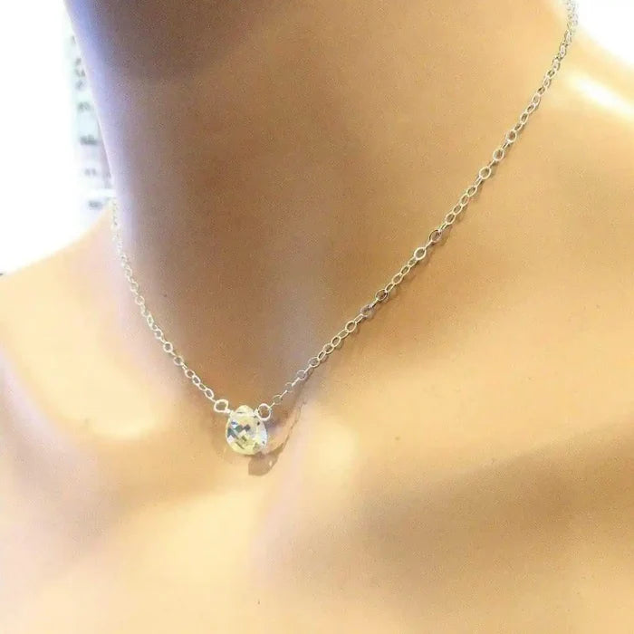 Sterling Silver Wire Wrapped Crystal Briolette Drop Necklace displayed on a mannequin, featuring a sparkling Swarovski crystal pendant.