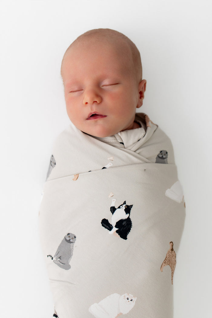Close up of sleeping newborn wearing the Swaddle Blanket in Fluffy Cat