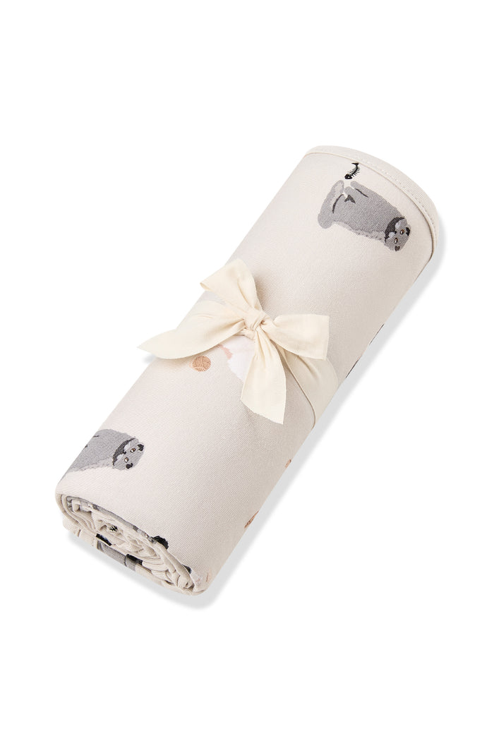 Swaddle Blanket in Fluffy Cat rolled in its packaging tied with a linen bow
