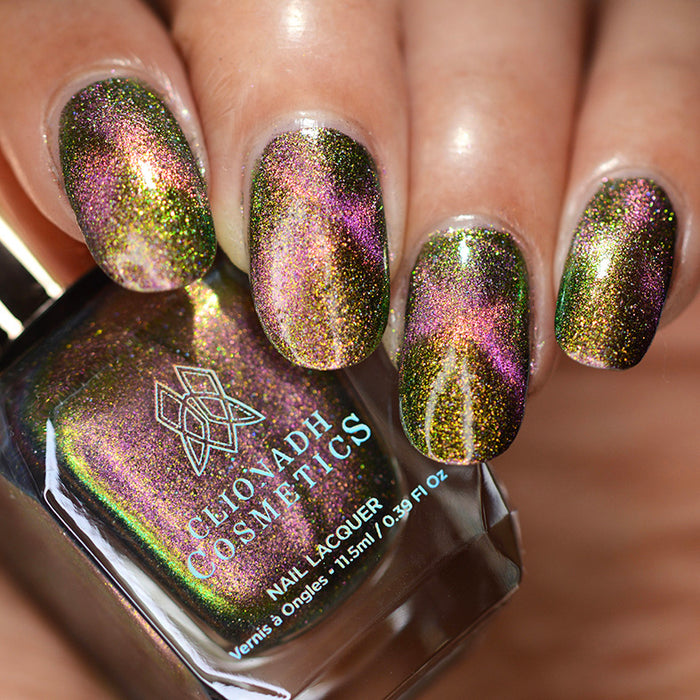 Close up of nails done with Synesthesia nail lacquer featuring a design to show off the magnetic effect  on medium skin tone.