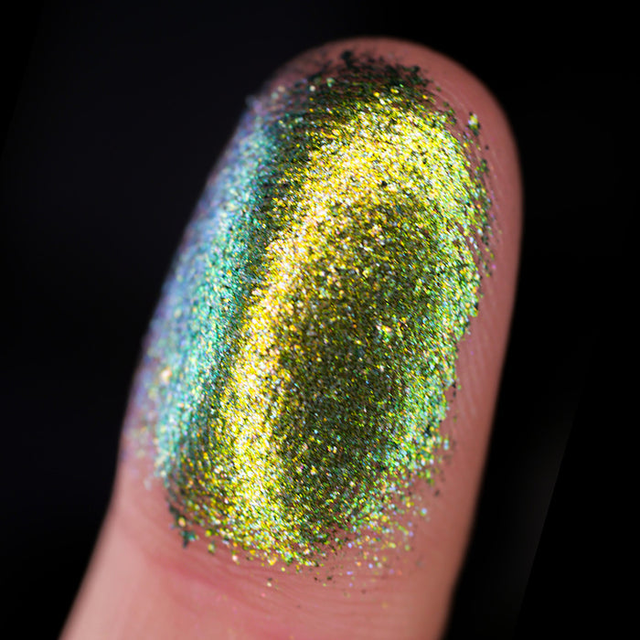 Macro finger swatch of Tarnish Dimensional Multichrome on fair skin tone.