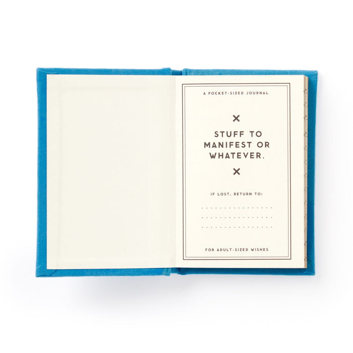 A hard-bound blue Tiny Hopes and Dreams Tiny Diary by Brass Monkey shows a title page reading “Stuff to manifest or whatever. If lost, return to:______. For adult-sized wishes.” The left page is blank.