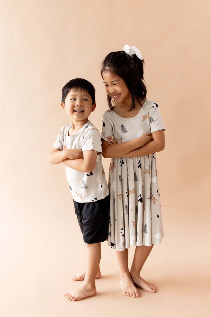 Boy and girl siblings matching in fluffy cat patterned tshirt and dress