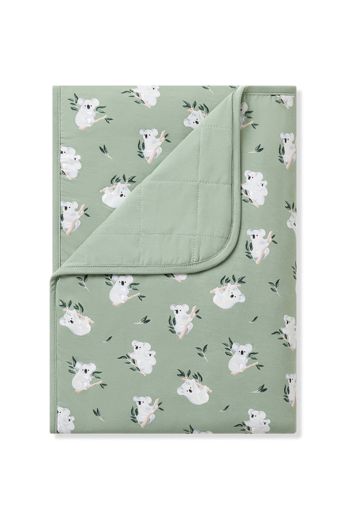 Toddler Blanket in Koala 1.0 with the corner flipped down showing the green quilted backing