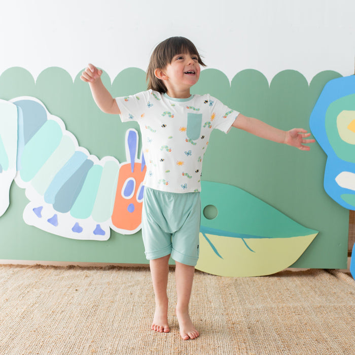 Child wearing Kyte Baby Toddler Crew Neck Tee with chest pocket in The Very Hungry Caterpillar™ and Friends