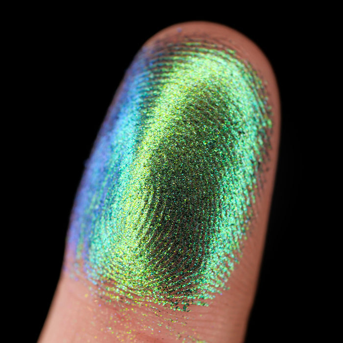 Macro finger swatch of Trefoil Lite on fair skin tone.