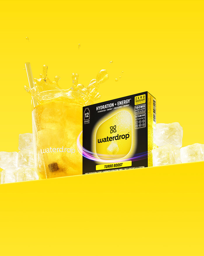 Microenergy Booster Set: glass with yellow fizzy drink, Turbo Boost cubes.
