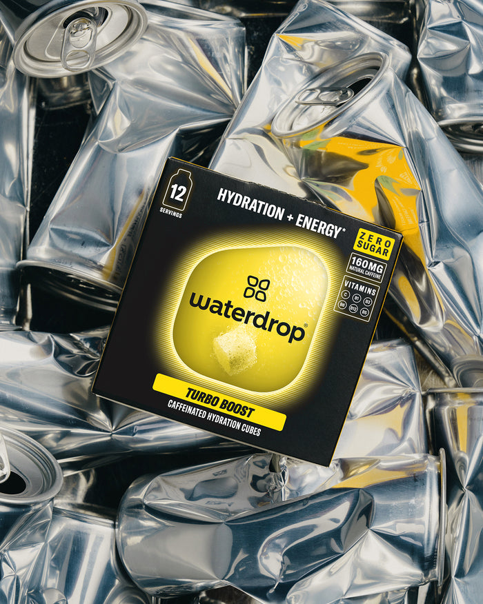 Microenergy 3+1 Turbo Boost cubes atop crushed cans.