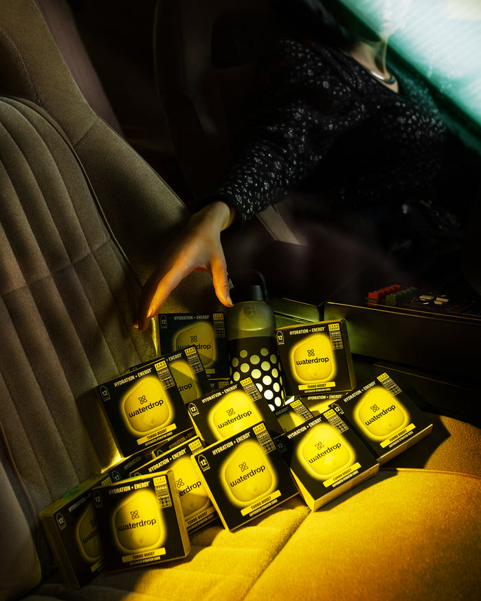 Microenergy BOOST Twin Pack on car seat with water bottle.