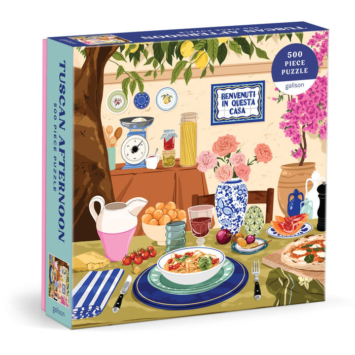 Ana Hard’s Tuscan Afternoon 500 Piece Puzzle features vibrant Italian food, flowers, drinks, and a “Benvenuti in questa casa” sign—perfect for cozy afternoons.