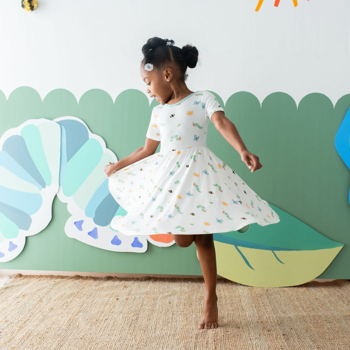 Girl twirling in Kyte Baby Short Sleeve Twirl Dress in The Very Hungry Caterpillar™ and Friends
