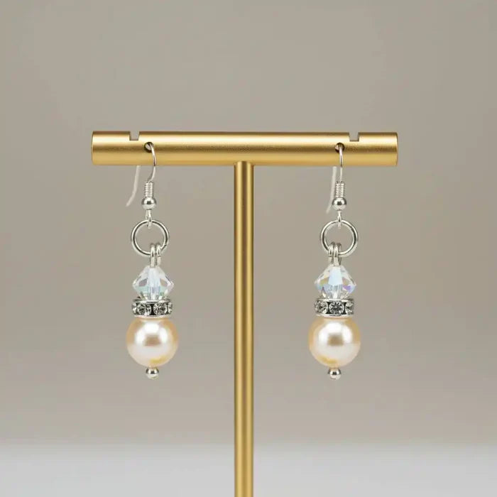Various Color Swarovski Crystal Pearl Stack Earrings displayed on a stand with elegant design.