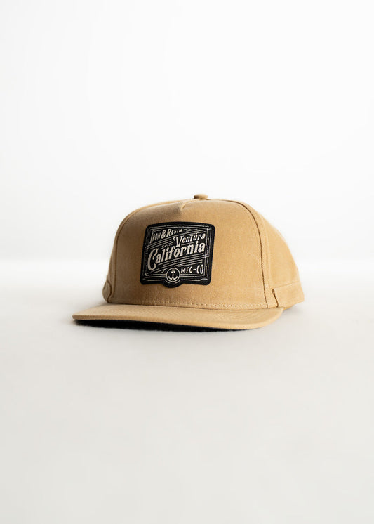 Tan cap with "Ventura California" patch, black text, on white background. Simple, stylish design.