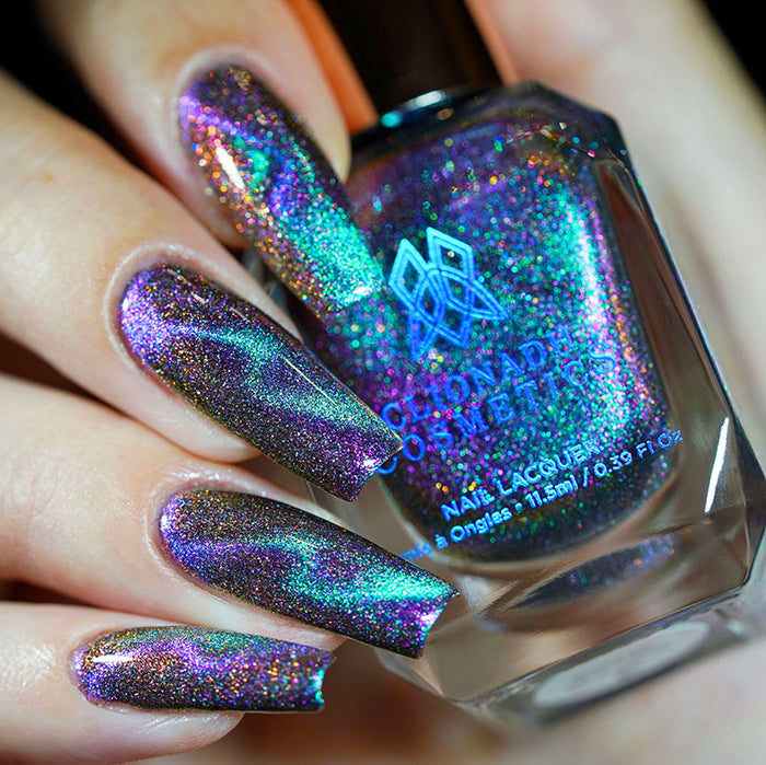 Close up of nails done with Warped Nail Lacquer featuring a design to show off the magnetic effect on fair skin tone