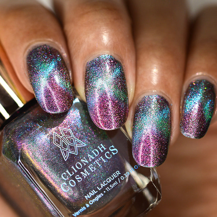 Close up of nails done with Warped Nail Lacquer featuring a design to show off the magnetic effect on medium skin tone.