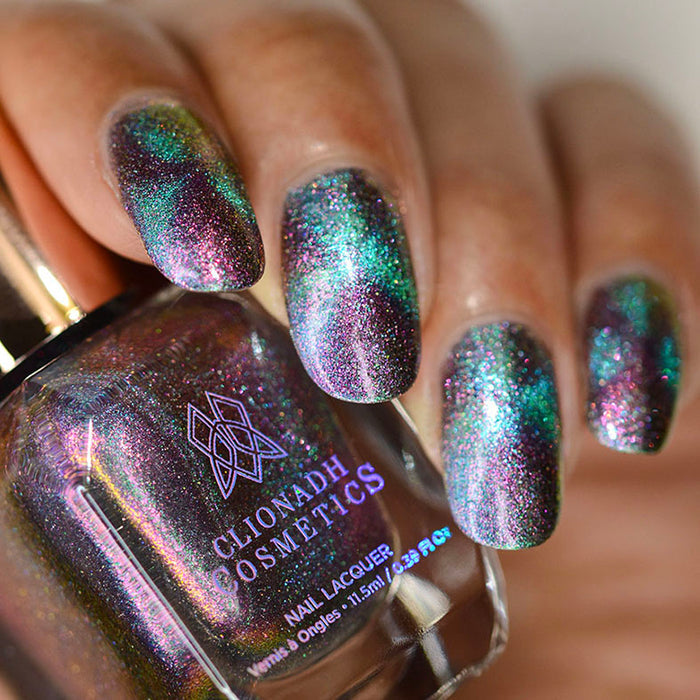 Close up of nails done with Warped Nail Lacquer featuring a design to show off the magnetic effect on medium skin tone