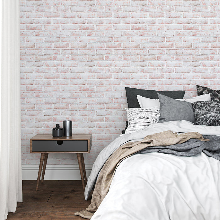 Tempaper's Whitewashed Brick Peel And Stick Wallpaper in a bedroom behind a bed and nightstand.
#color_whitewashed