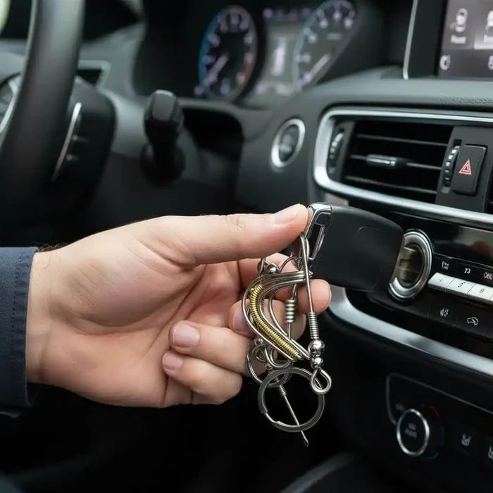 Wire Coiled Birdie Keychain For Him - Limited Edition in hand, attached to car keys, inside a vehicle's dashboard.
