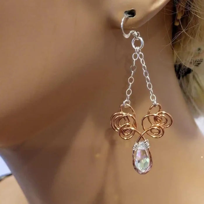 Wire Sculpted Crystal Drop Chandelier Angel Wing Earrings showcased on a mannequin ear, highlighting their unique design.