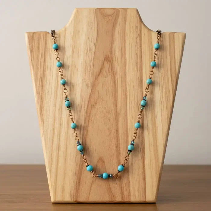 Wire Wrapped 24 Inches Copper Turquoise Necklace displayed on a wooden stand, featuring turquoise gemstones and antiqued copper.