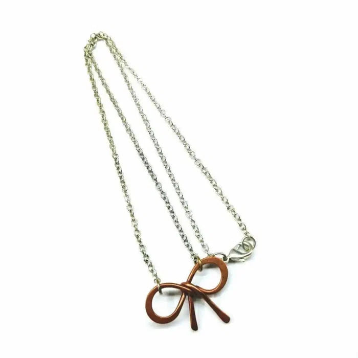Wire Wrapped Copper Bow Tie Silver Chain Necklace on a white background showcasing the unique design and craftsmanship.