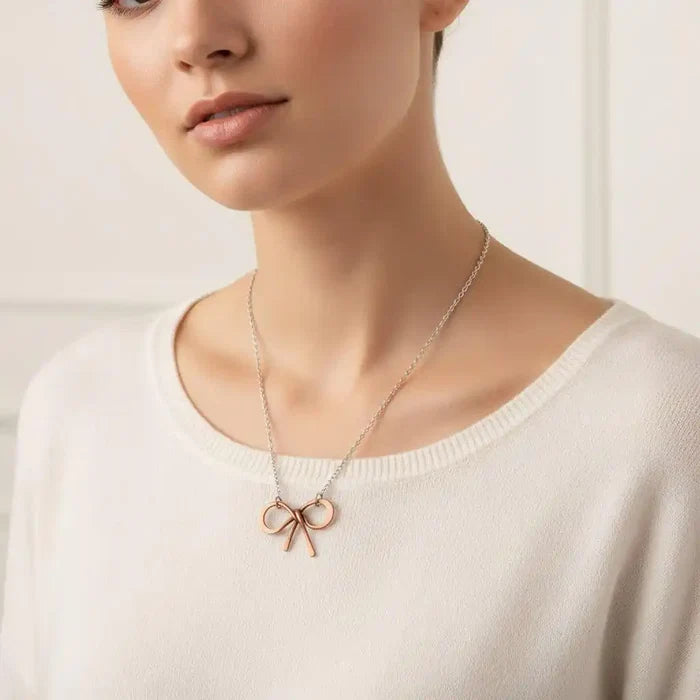 Wire Wrapped Copper Bow Tie Silver Chain Necklace worn by a model, showcasing its unique design and artisan craftsmanship.