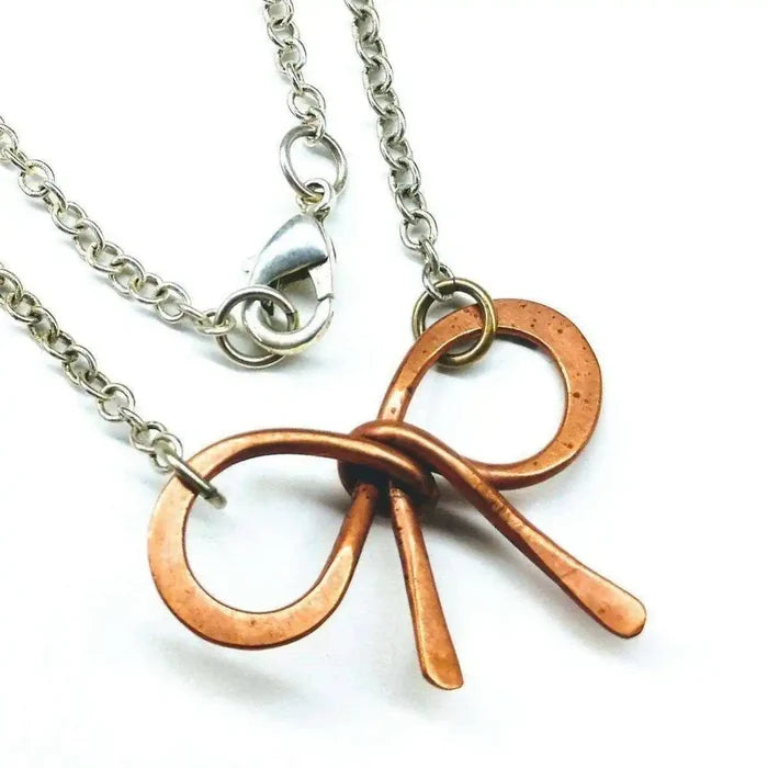 Wire Wrapped Copper Bow Tie Silver Chain Necklace featuring a hand-sculpted copper pendant on a silver chain.