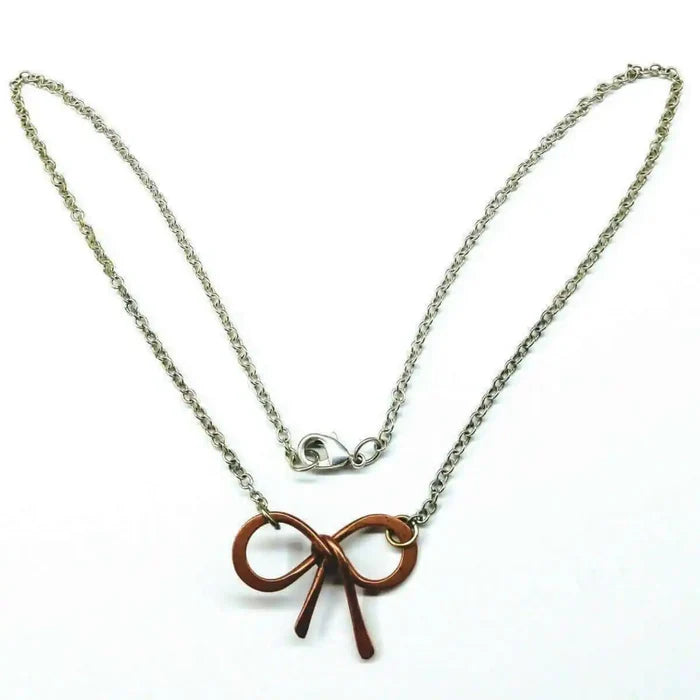 Wire Wrapped Copper Bow Tie Silver Chain Necklace with hand-sculpted copper pendant and sterling silver chain.