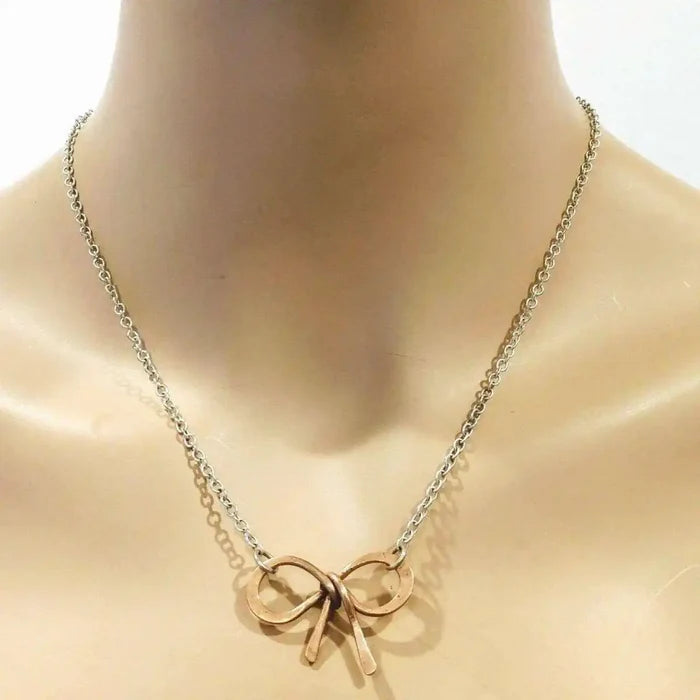 Wire Wrapped Copper Bow Tie Silver Chain Necklace featuring a hand-sculpted copper bow tie pendant on a silver chain.