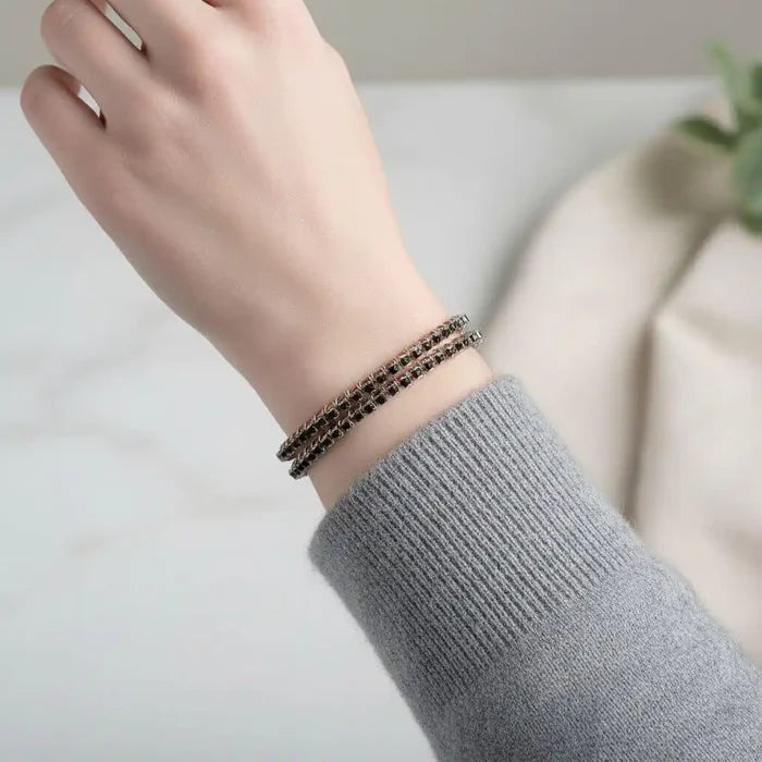 Wire Wrapped Copper Silver Black Crystal Rhinestone Bangle worn on a wrist with a gray sweater.