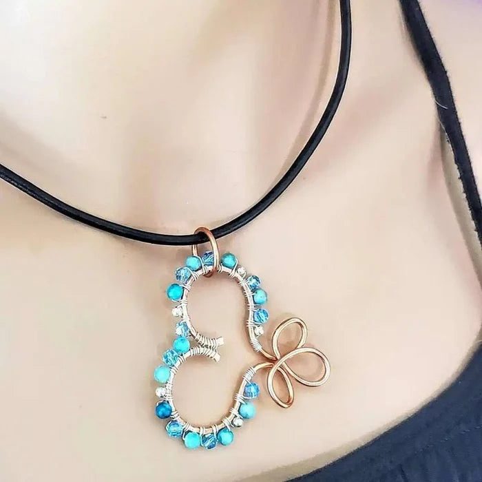 Wire Wrapped Copper Turquoise Heart Infinity Charm Necklace featuring turquoise beads and a copper heart pendant.