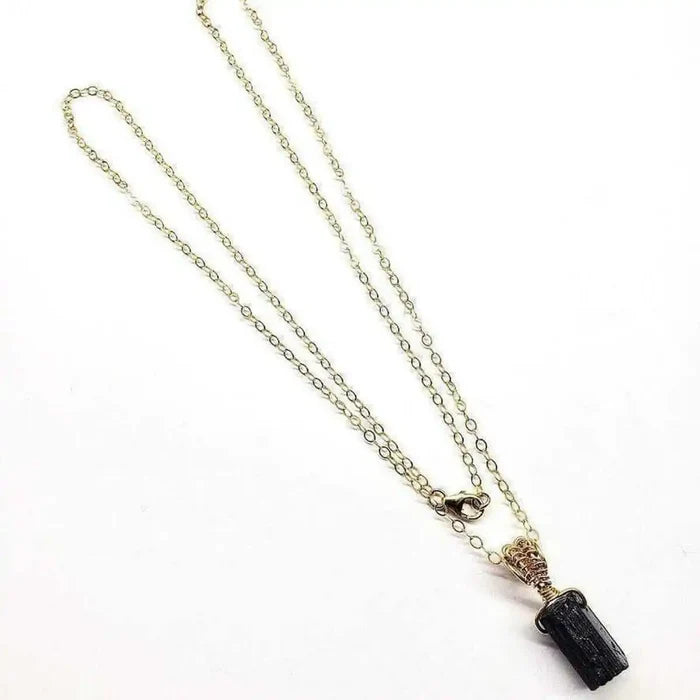 Wire Wrapped Raw Black Tourmaline Gemstone Necklace on a delicate chain in an elegant display.