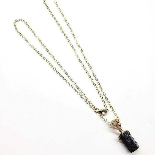 Wire Wrapped Raw Black Tourmaline Gemstone Necklace on a delicate chain in an elegant display.