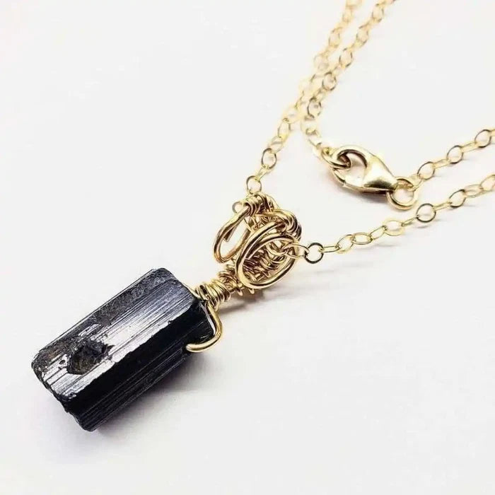 Wire Wrapped Raw Black Tourmaline Gemstone Necklace showcasing a natural black tourmaline crystal wrapped in gold wire.